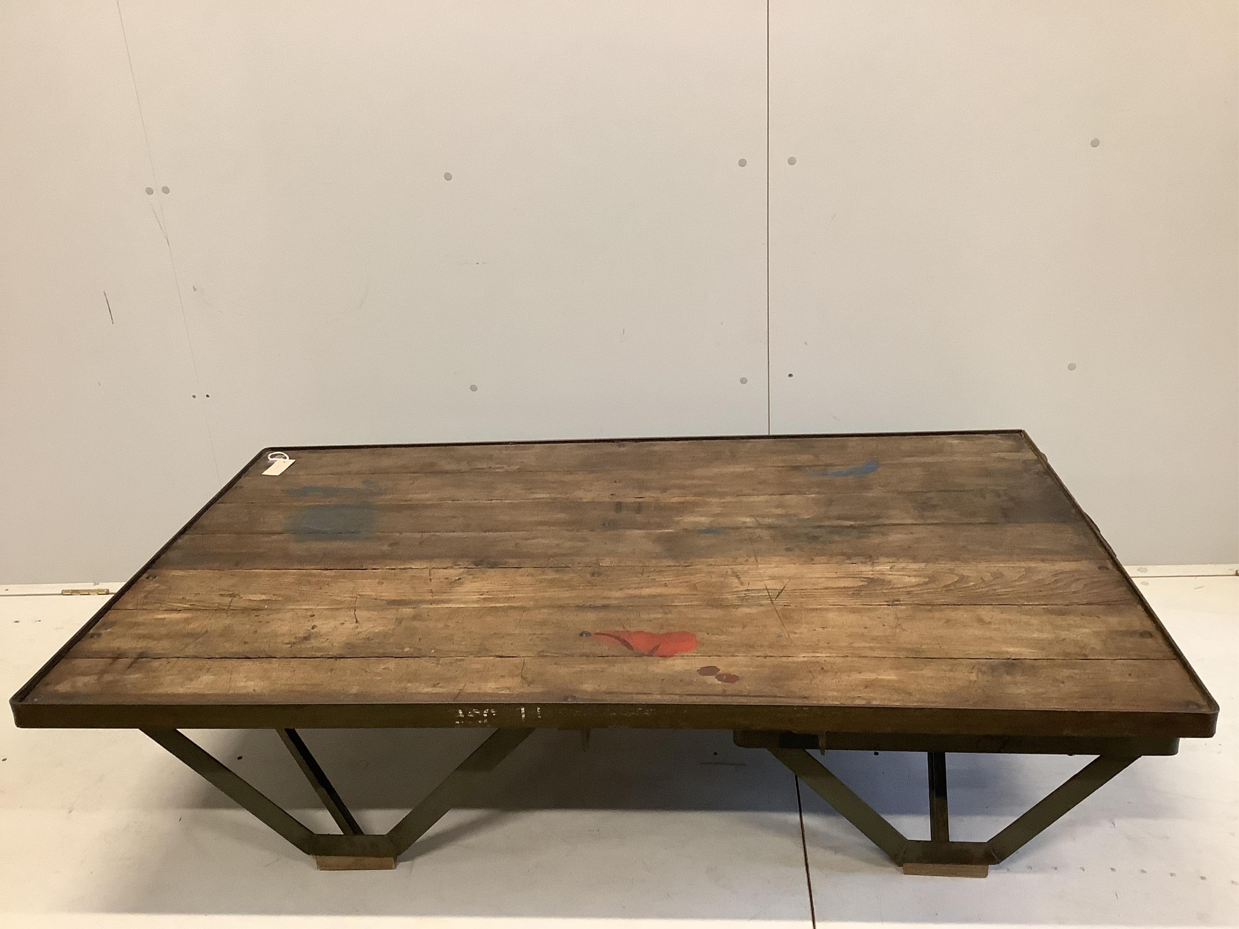 An Industrial style cast iron and planked oak coffee table converted from a Second War British military turntable, width 152cm, depth 92cm, height 38cm. Condition - good.